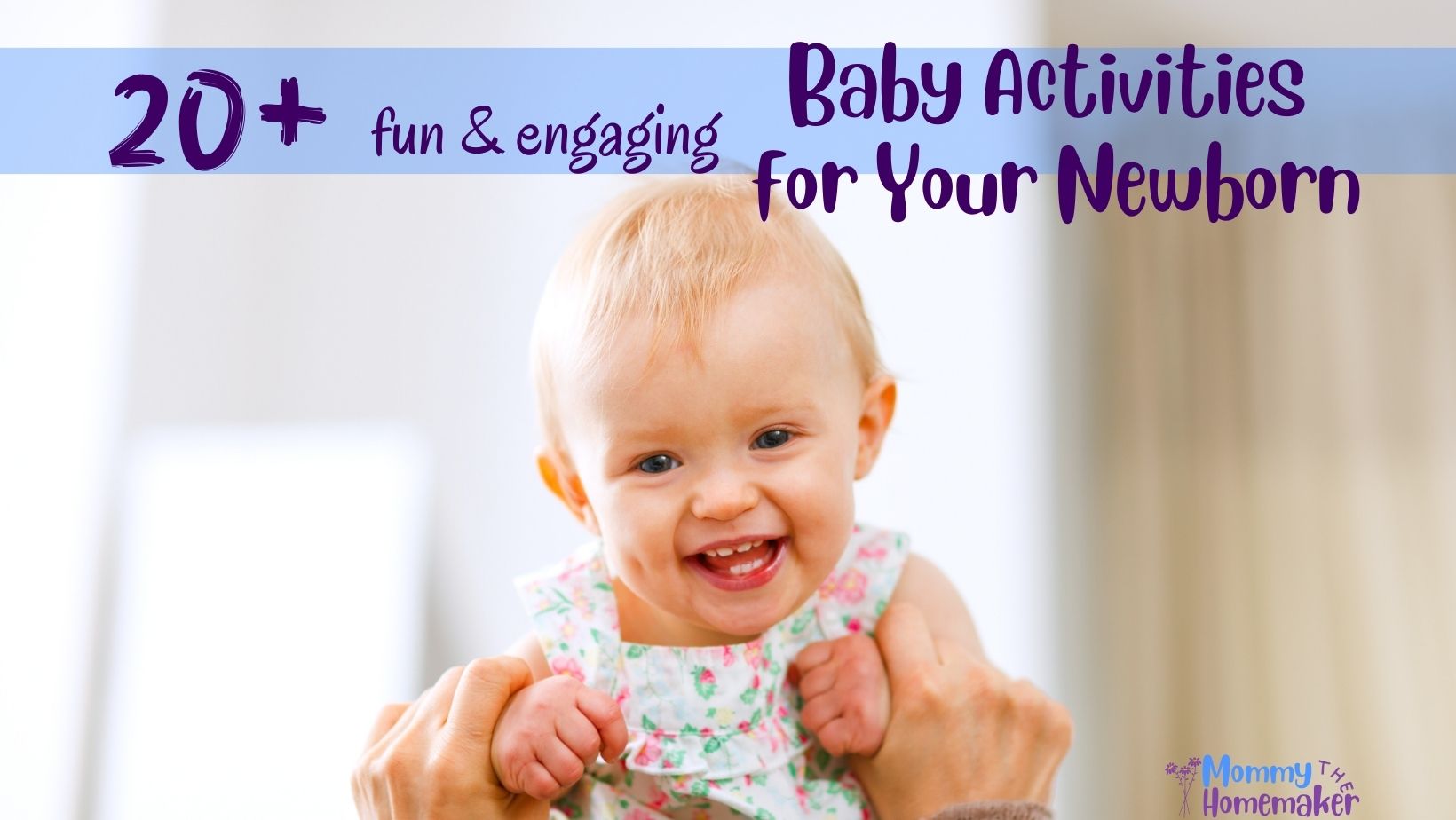 smiling baby girl being held up by parent and looking into camera