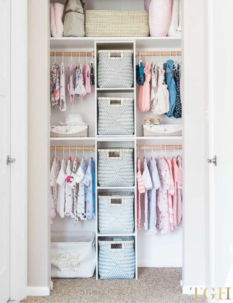 nursery closet with cubed shelving and four clothing rods, two on each side, for clothing