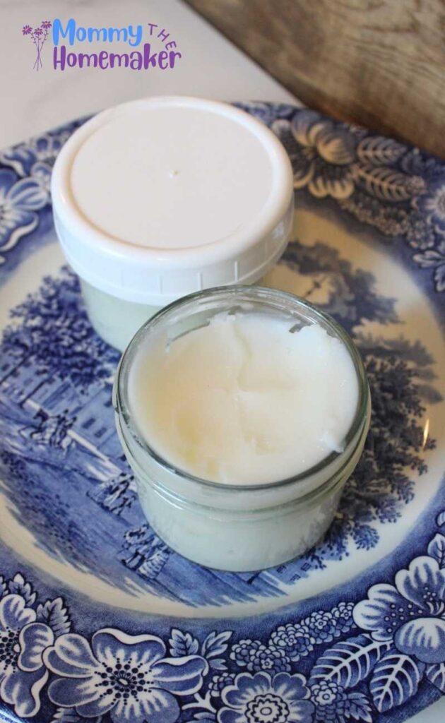 graphic with breastmilk lotion in a small glass jar on a blue plate